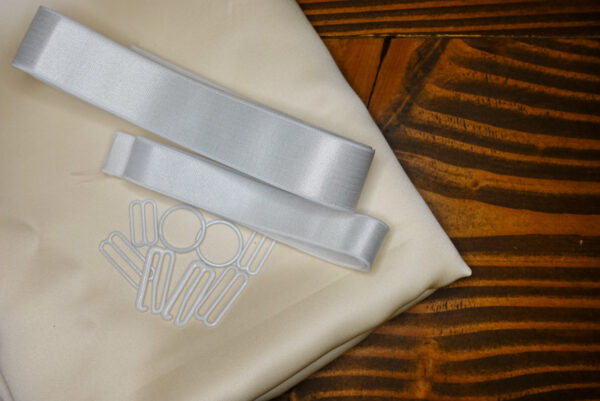 The Ivory Satin Jet Set Kit features ivory satin fabric; white elastic; and white rings, g hooks, and sliders.