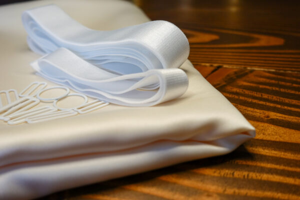 The Ivory Satin Jet Set Kit features ivory satin fabric; white elastic; and white rings, g hooks, and sliders.