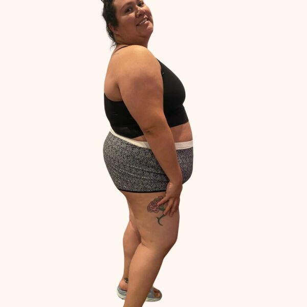 A side view of a model wearing the Constellation Panty Pattern in a black and white patterned fabric with white elastic and a black bralette.